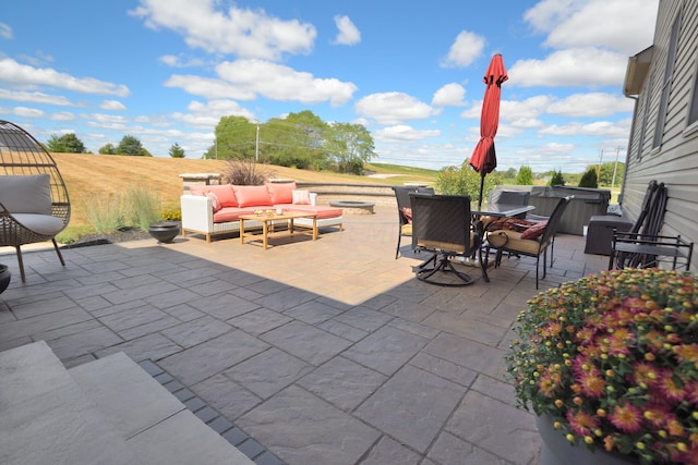 view of patio / terrace featuring an outdoor hangout area and a hot tub