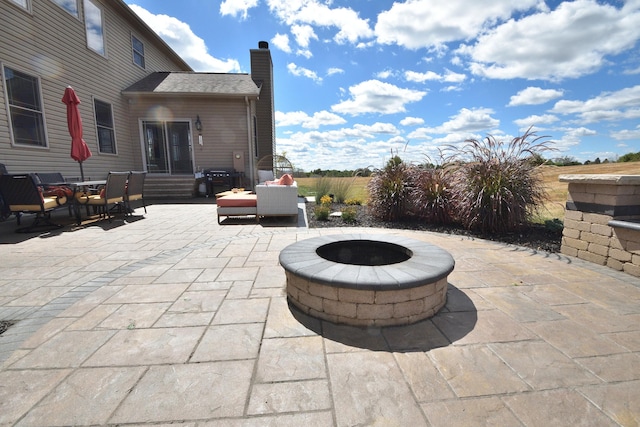 view of patio with an outdoor fire pit