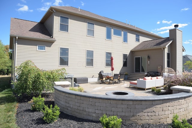 rear view of house featuring a patio and an outdoor hangout area