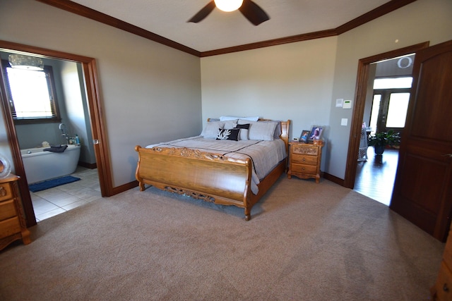 carpeted bedroom with ceiling fan and ornamental molding