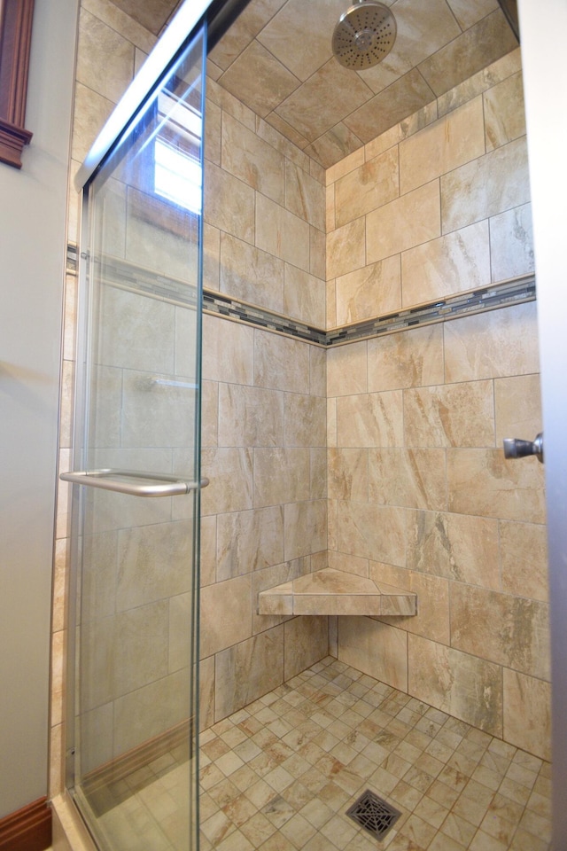 bathroom featuring a shower with door