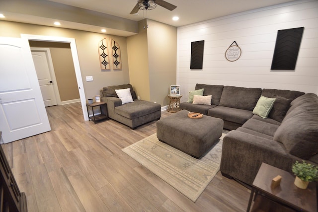 living room with light hardwood / wood-style floors and ceiling fan