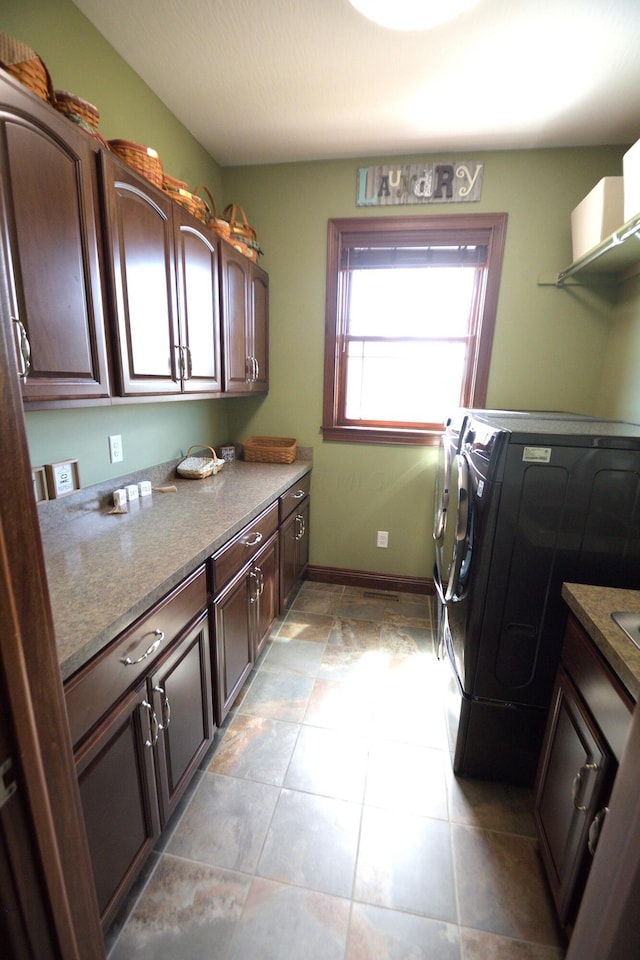 laundry room featuring washing machine and dryer and cabinets