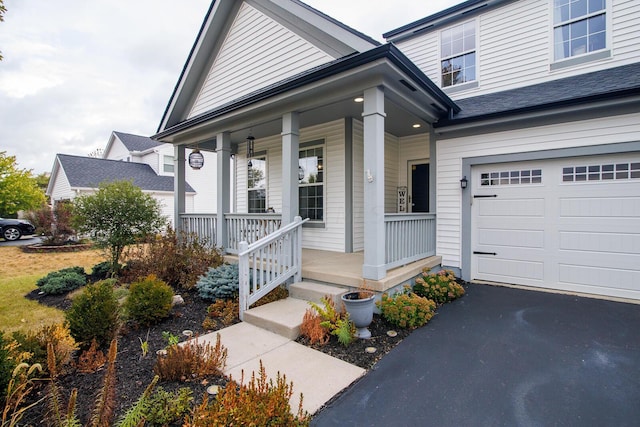 view of front of property with a porch and a garage