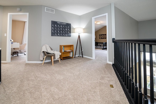 living area featuring carpet floors and vaulted ceiling