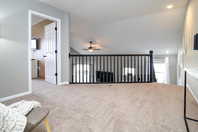 interior space featuring carpet floors, vaulted ceiling, and ceiling fan