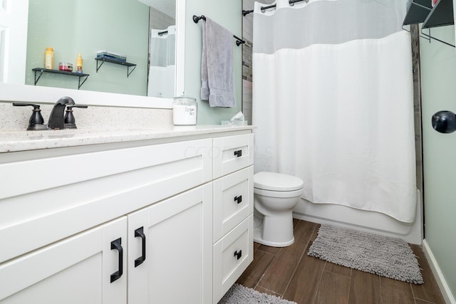 full bathroom with vanity, toilet, wood-type flooring, and shower / tub combo with curtain