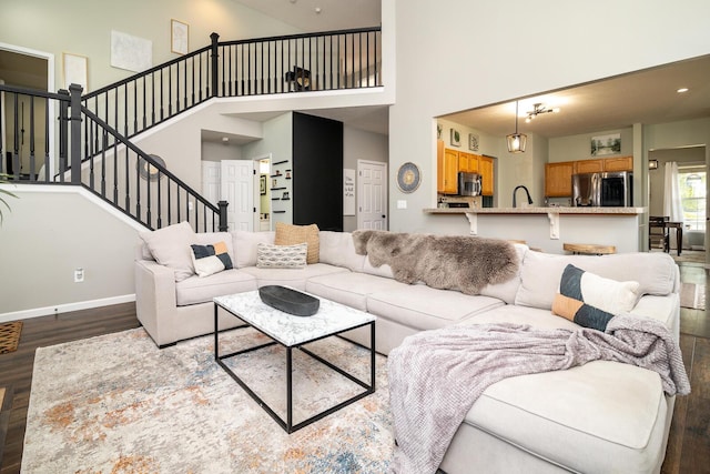 living room featuring dark hardwood / wood-style flooring and a high ceiling