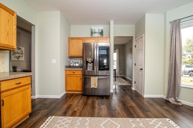 kitchen featuring dark hardwood / wood-style floors, stainless steel fridge with ice dispenser, and a textured ceiling