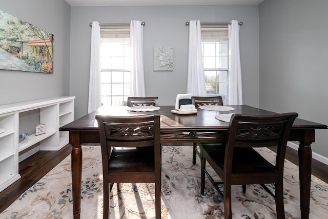 dining area featuring plenty of natural light and dark hardwood / wood-style floors