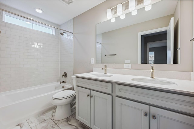 full bathroom with vanity, toilet, and tiled shower / bath