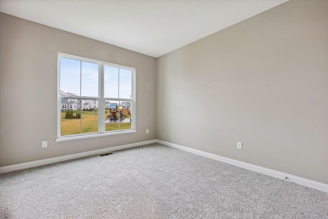 unfurnished room with a healthy amount of sunlight and carpet floors