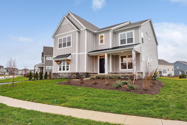 view of front of property featuring covered porch and a front yard