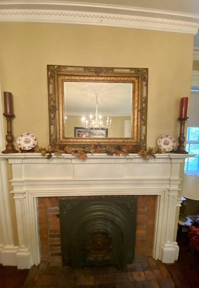 room details featuring hardwood / wood-style floors, ornamental molding, and a notable chandelier