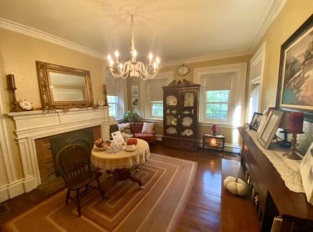 sitting room with a chandelier, dark hardwood / wood-style flooring, and ornamental molding