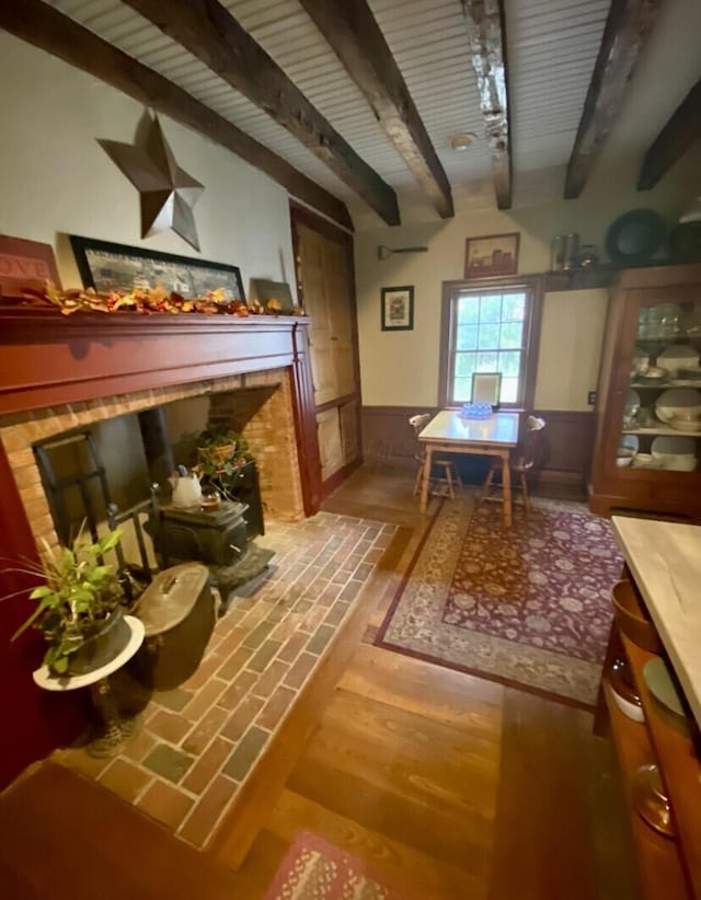 interior space featuring beamed ceiling and hardwood / wood-style floors