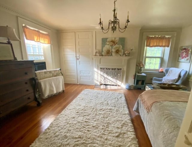 bedroom featuring a closet, hardwood / wood-style floors, and a notable chandelier