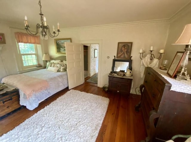 bedroom featuring crown molding, dark wood-type flooring, and an inviting chandelier