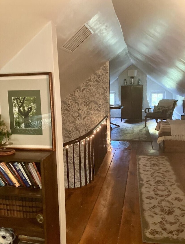 additional living space featuring lofted ceiling and dark wood-type flooring