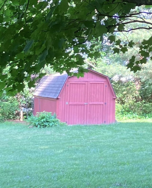 view of outdoor structure with a lawn