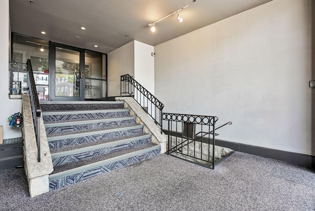 stairs featuring carpet floors