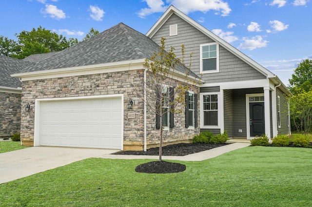 view of front of home with a front yard and a garage