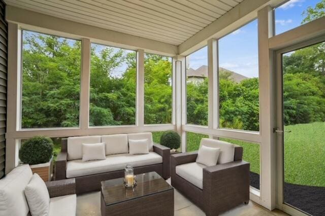 sunroom / solarium featuring wood ceiling