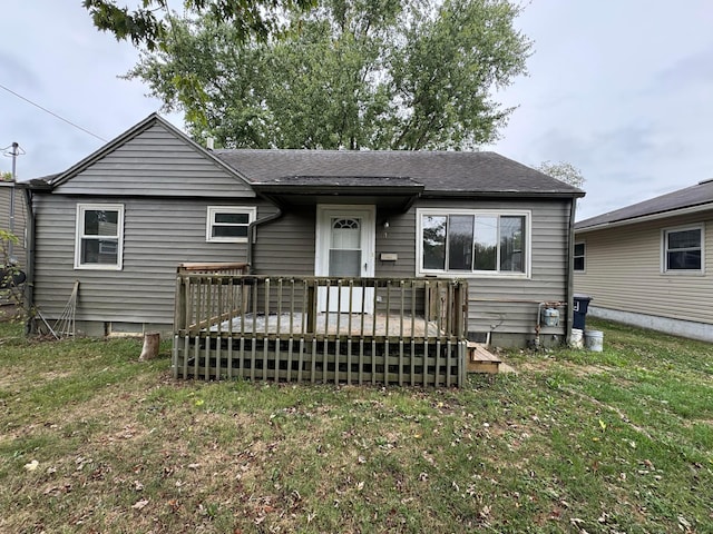 view of front of house featuring a front lawn and a deck