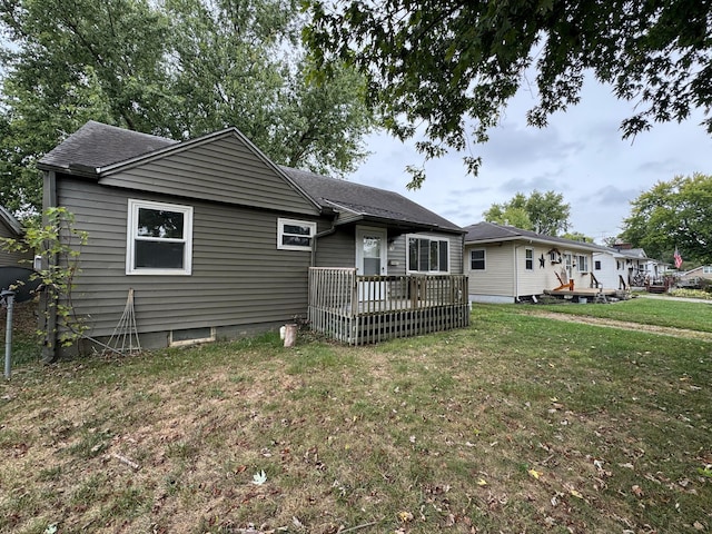 view of front of house featuring a deck and a front lawn