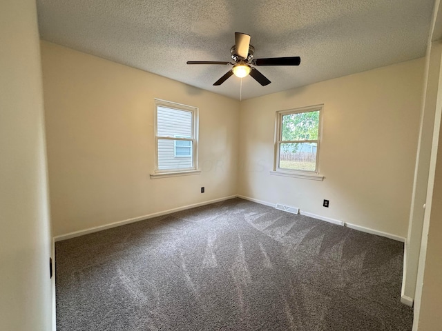 carpeted empty room featuring a textured ceiling and ceiling fan