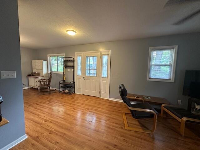 foyer entrance with a textured ceiling and hardwood / wood-style flooring