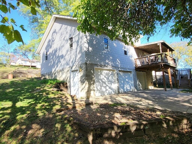 exterior space with a lawn, a garage, and a deck