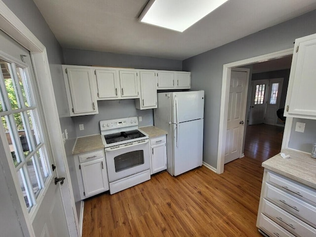 kitchen featuring white cabinets, white appliances, and light wood-type flooring