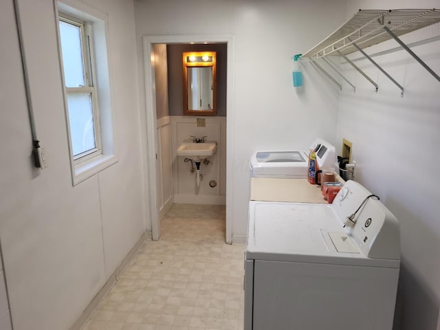 laundry area with sink and independent washer and dryer