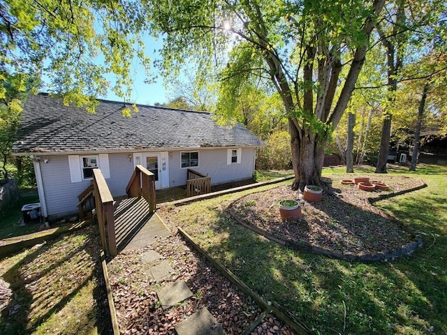 rear view of house featuring a yard