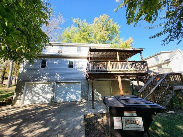 back of property featuring a garage and a wooden deck