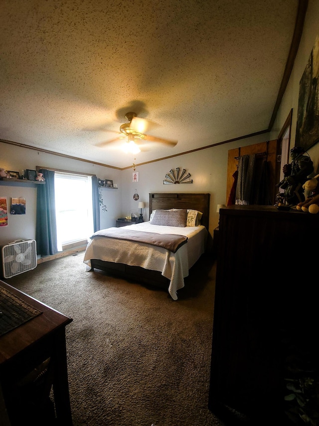 carpeted bedroom featuring ceiling fan and a textured ceiling