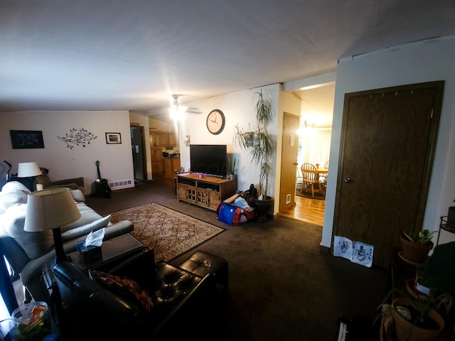 carpeted living room featuring ceiling fan and vaulted ceiling