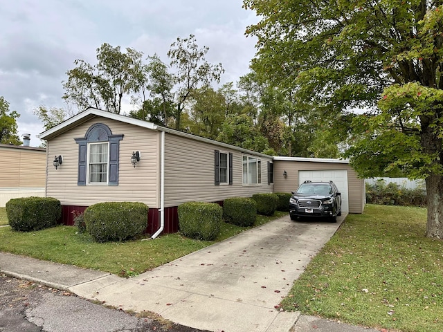 view of front of house featuring a front yard and a garage