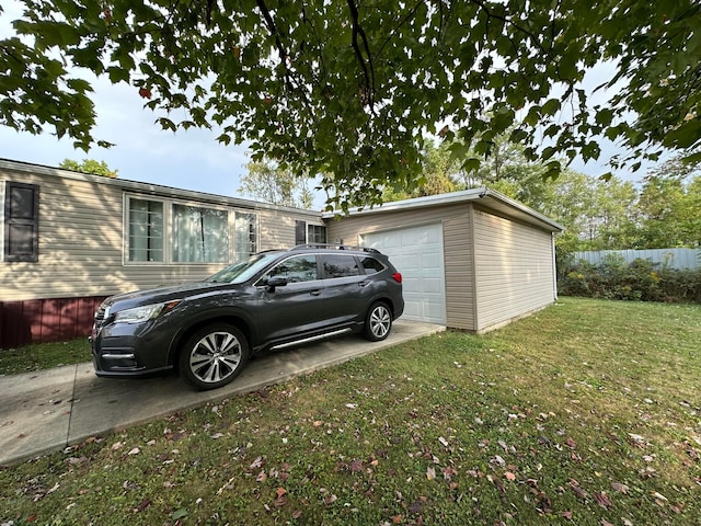 view of side of home featuring a garage and a lawn