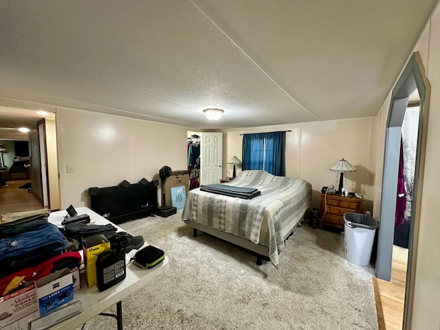 bedroom featuring wood-type flooring and a textured ceiling