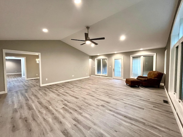 unfurnished living room featuring ceiling fan, light hardwood / wood-style floors, and lofted ceiling