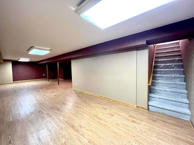 basement with hardwood / wood-style floors