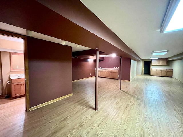 basement featuring light hardwood / wood-style floors