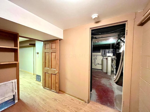 corridor with wood-type flooring