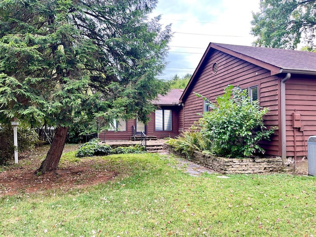 view of property exterior with a yard