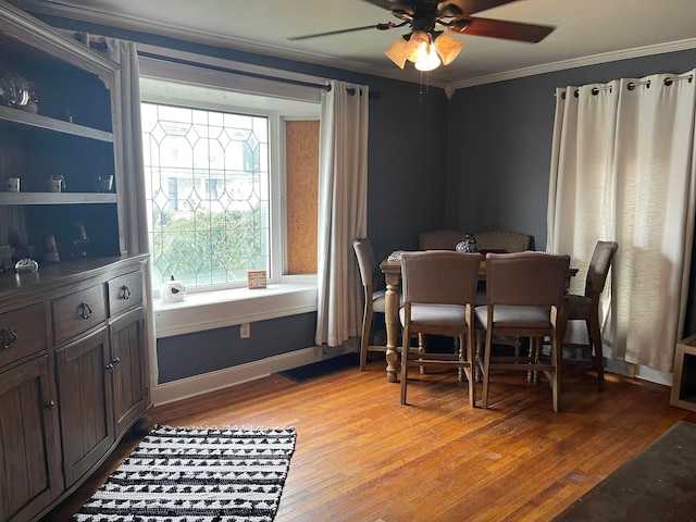 dining room with ceiling fan, light hardwood / wood-style floors, and crown molding