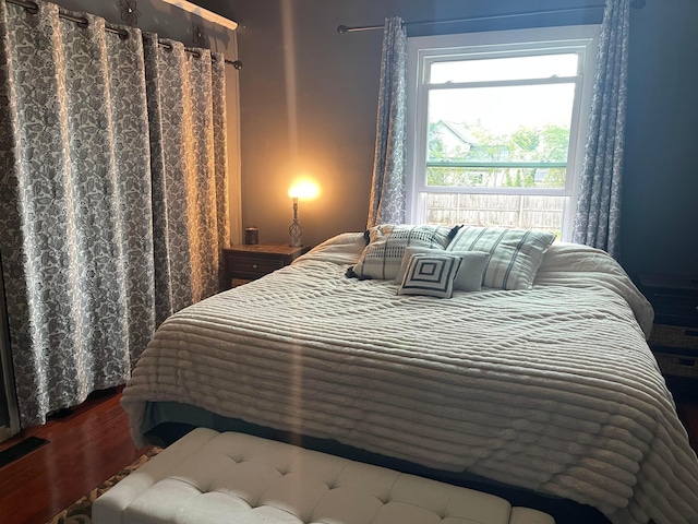 bedroom with hardwood / wood-style flooring