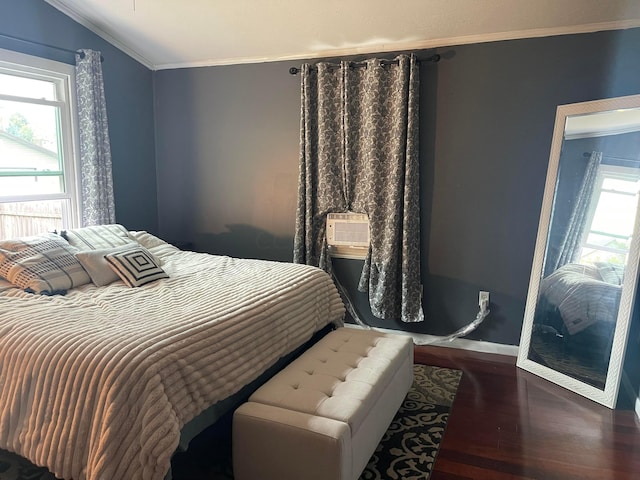 bedroom featuring multiple windows, crown molding, hardwood / wood-style floors, and vaulted ceiling