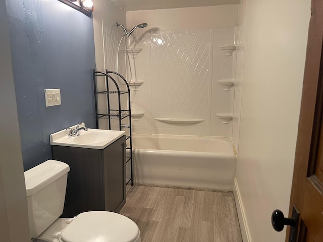 full bathroom featuring vanity, wood-type flooring, bathtub / shower combination, and toilet